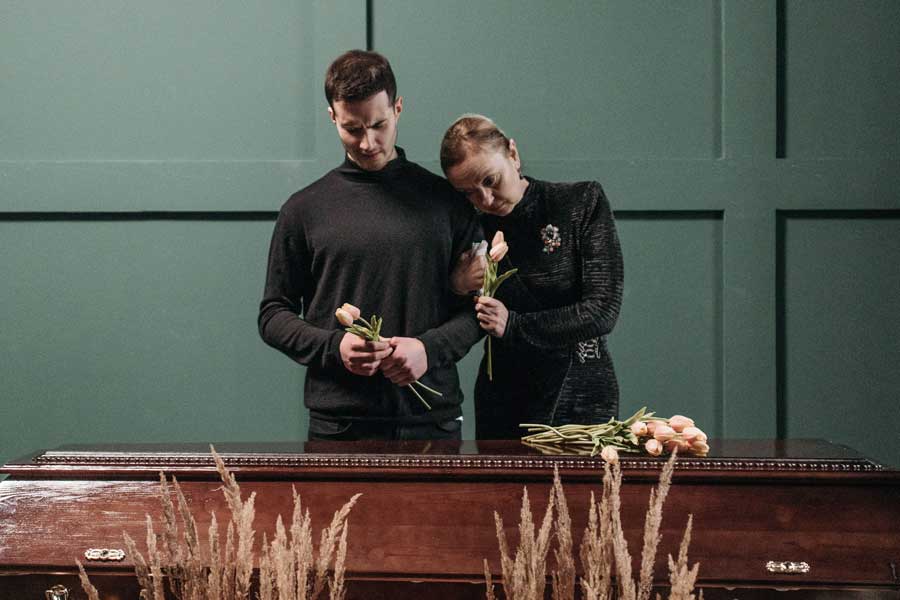 Family saying farewell together with flowers