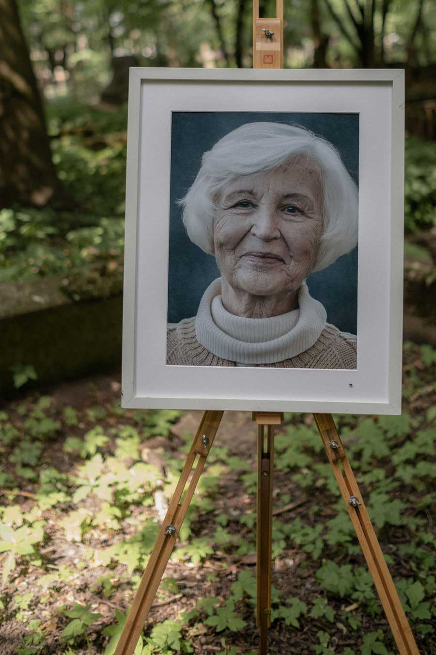 Framed memorial photo on an easel at the funeral service