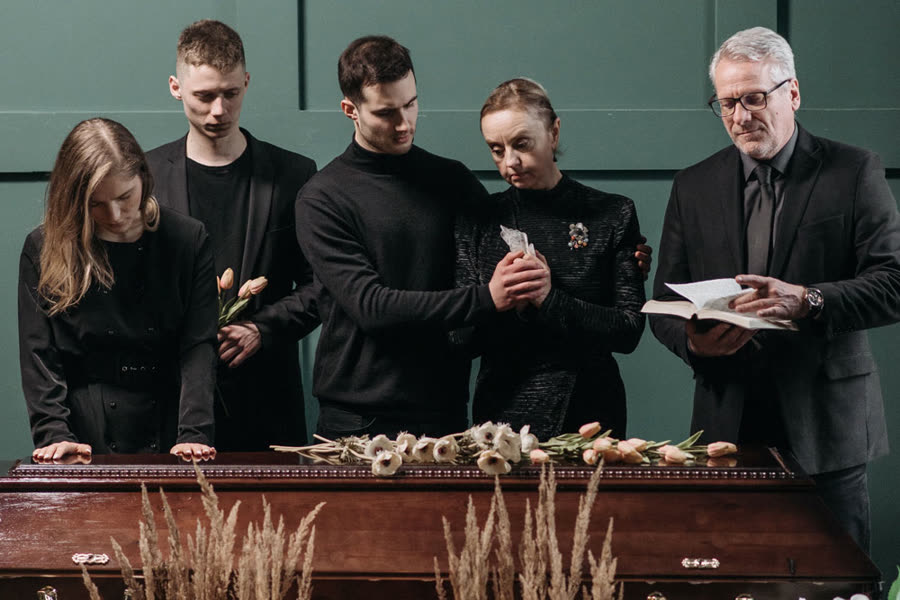 A funeral director preparing a service in the funeral hall